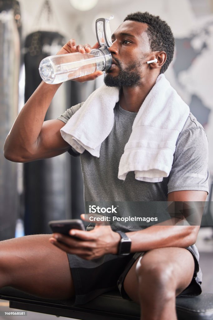 Water Bottle Black Man In Gym And Smartphone For Social Media After Fitness  Exercise Healthy Sports Workout And Muscle Growth Wellness Work Out  Training Motivation And A Tired Guy Drinking Water Stock