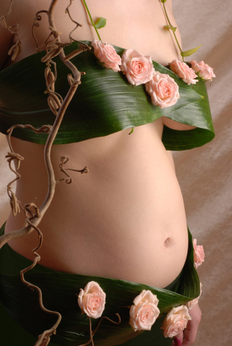 Pregnancy woman in the dressing made of a flowers