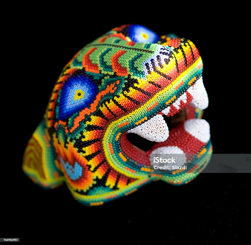 A very colorful knitter jaguar head Huichol tradicional mask - jaguar head made from plastic beads Bead Stock Photo