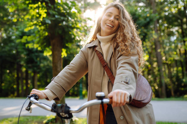 istock Beautiful woman  riding bicycle in  park. 1469571436