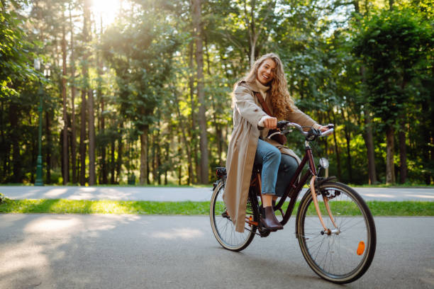 istock Beautiful woman  riding bicycle in  park. 1469571441