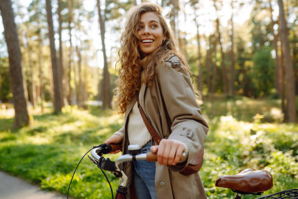 istock Beautiful woman  riding bicycle in  park. 1469571462