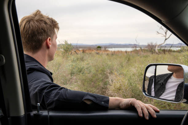 istock Young professional looks out across landscape while waiting with vehicle 1469574248