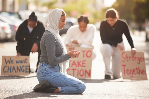 Protest, Islamic woman and pray in street, group and support for Palestine. Muslim female, girl or protesters with cardboard signs, fight for justice or change in society for oppression or solidarity