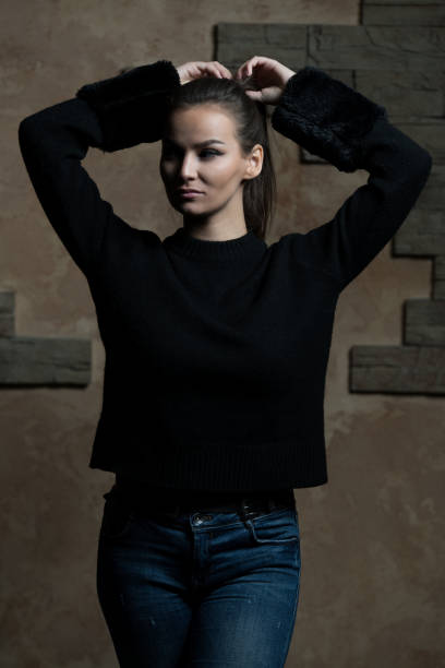 istock Woman Standing Against a Brick Wall 1469583369
