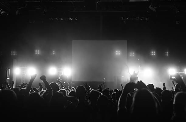istock Cheering crowd raising hands in the air in front of a stage 146959162