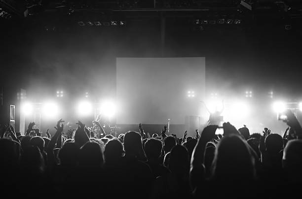 istock Cheering people crowded in front of bright lights and screen 146959294