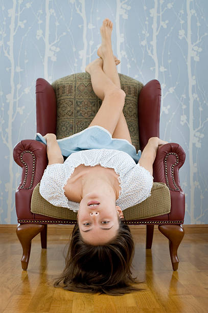 istock Woman upside-down in armchair 146959457