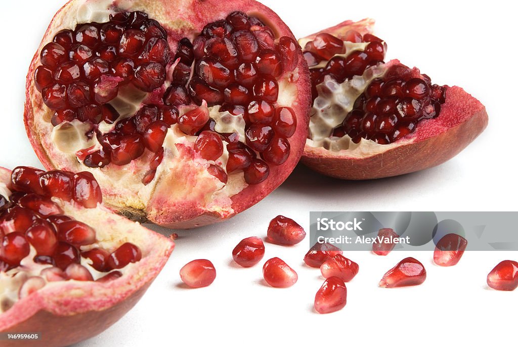 Pomegranate Pomegranate in a section on white background Adult Stock Photo