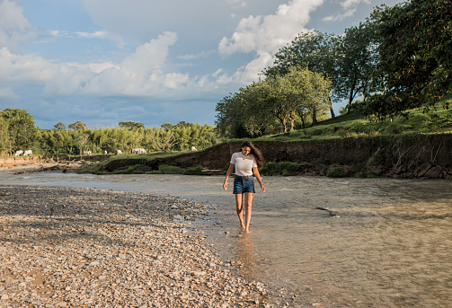 Young woman outdoors enjoying the river in the Cauca Valley of Colombia