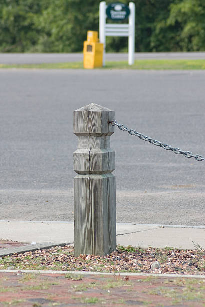 istock Wooden post and chain in parking lot 146960215