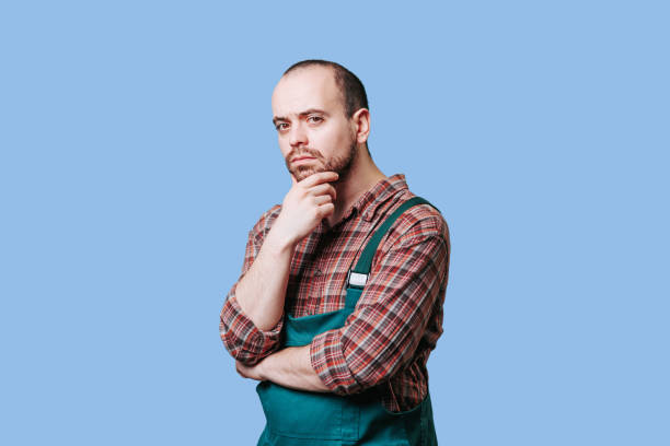 istock Pensive bearded young workman in studio shot, Meditative 1469602414