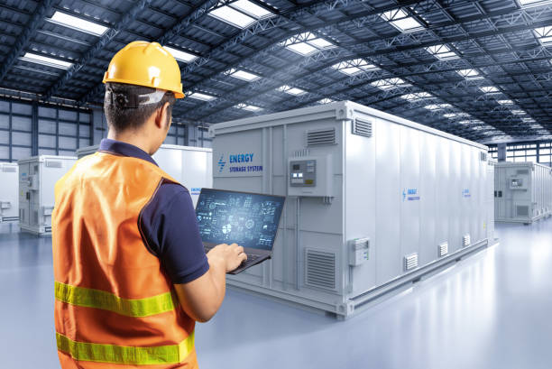 Engineer control energy storage system or battery container unit in factory stock photo
