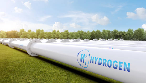 Metal pipeline with green field and blue sky background stock photo