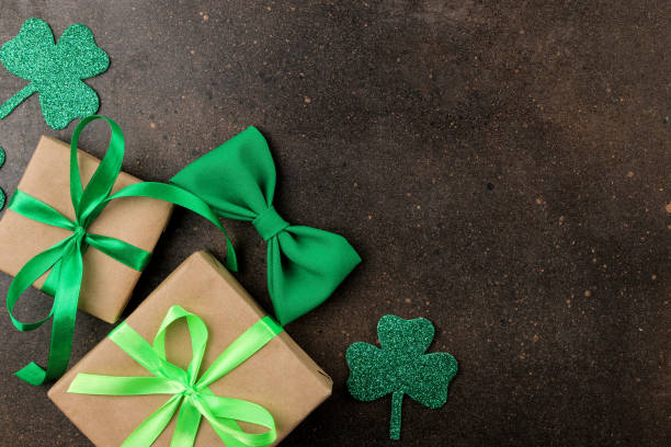 istock St.Patrick 's Day. celebration. Bow tie, horseshoe, gift boxes and clover on a brown background. view from above. space for text 1469602742