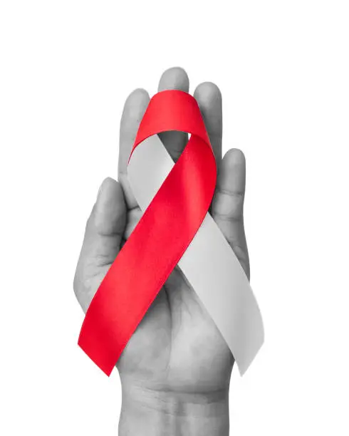 Photo of Red white awareness ribbon for Aplastic Anemia, Deep Vein Thrombosis (DVT), Hereditary Hemorrhagic Telangiectasia, Oral Cancer, Squamous Cell Carcinoma, bow isolated with clipping path