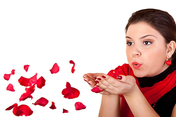 istock girl blowing red petals 146960521