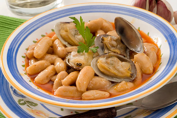 Spanish Cuisine. Asturian clams and beans. stock photo