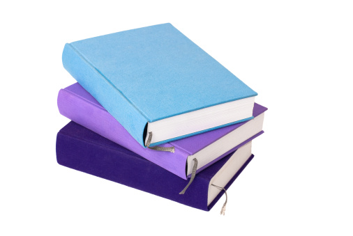 A stack of three empty colored books on isolated white background.