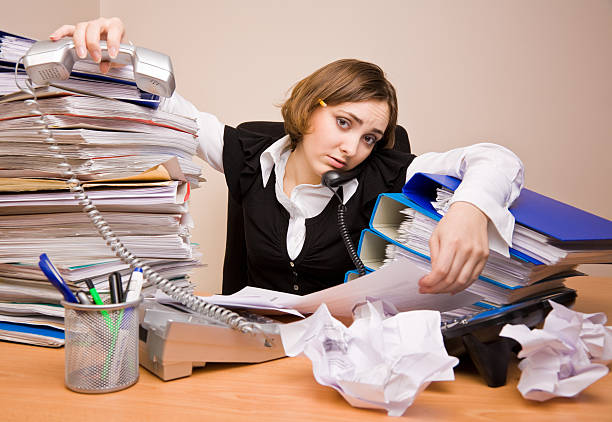 istock Young businesswoman with tons of documents 146962301