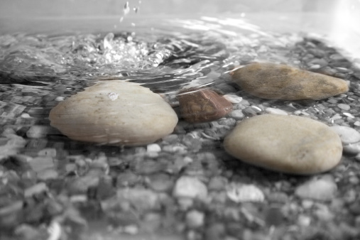 Pebbles underneath water giving an illusion effect