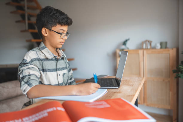 istock Boy studying online at home 1469628576