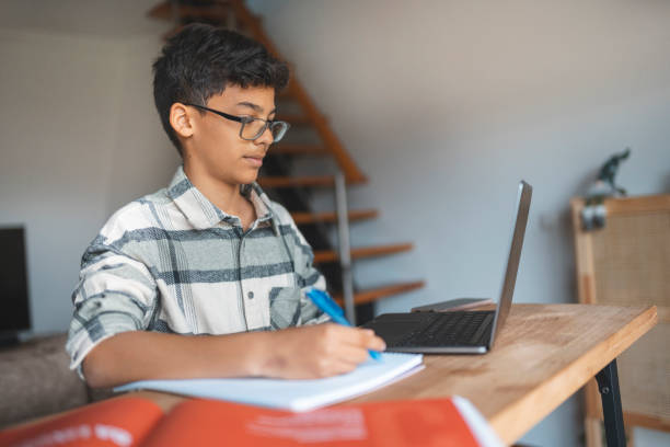 istock Boy studying online at home 1469628579