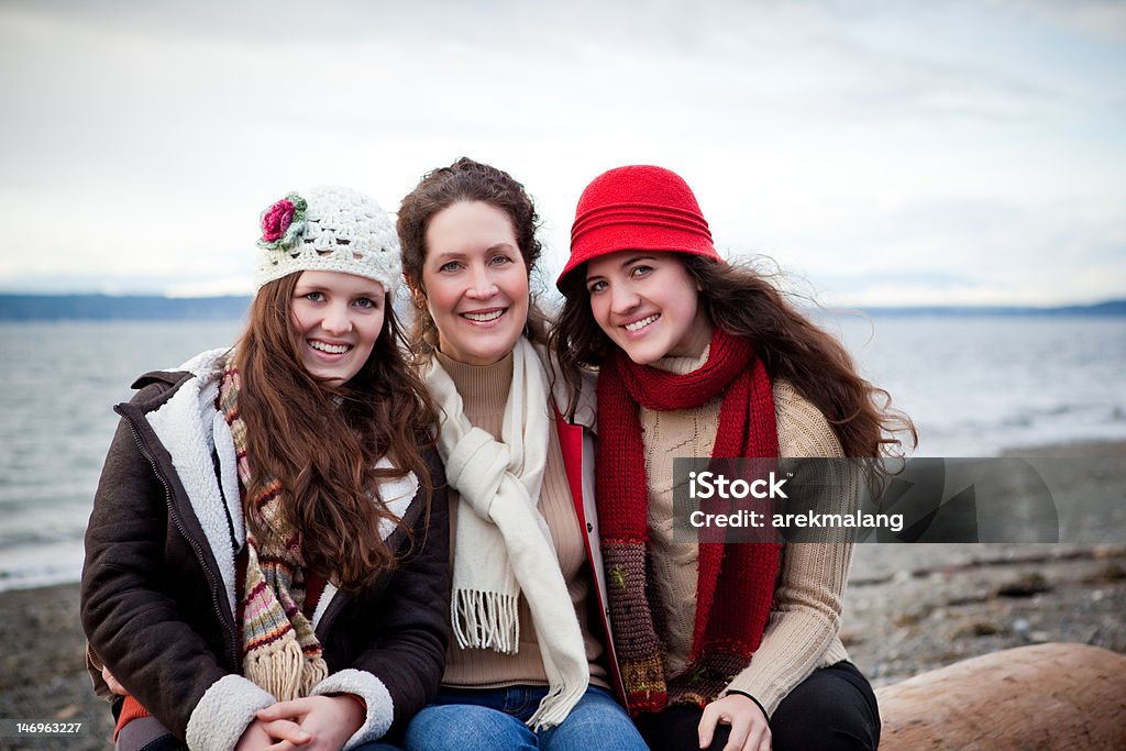 Mother and daughters A portrait of a mother and her daughters on the beach 50-59 Years Stock Photo