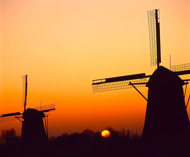 istock Windmills in silhouette at sunset 146963248