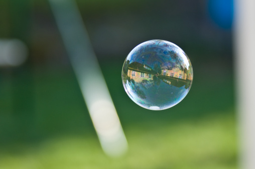 A house in a bubble. Maybe a symbol of being an owner of your own house is a dream that easily can burst like a bubble