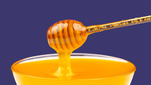 istock fresh fragrant honey drips from a spoon into a plate on a colored background. organic vitamin nutrition. dessert food 1469634789