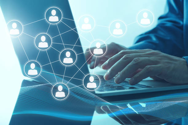 istock Communicating with people over internet. Laptop and illustration of people network structure. 1469637146