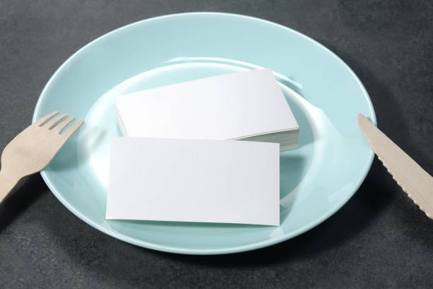istock Blank white mock-up business cards, porcelain blue plate on dark backgound table 1469637752