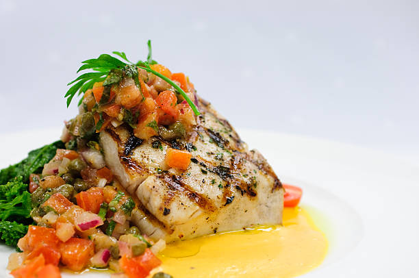 istock striped bass on greens with tomato caper salsa 146963833