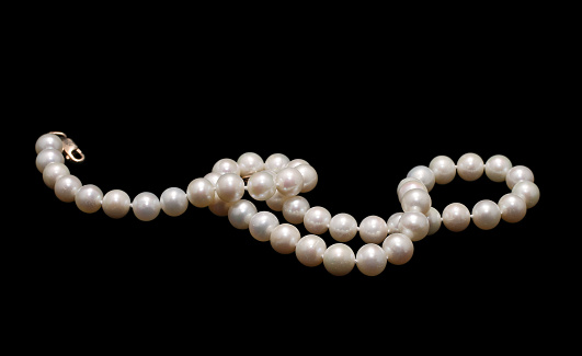 White pearl necklace on blue background
