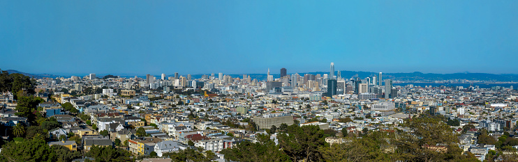 SAN FRANCISCO, CALIFORNIA - CIRCA OCTOBER, 2021: Downtown city skyline with urban panoramic views. Aerial panorama of a dense community with buildings and residences against blue sky on a sunny day.