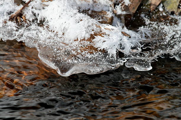 Ice Hanging over river with hoar frost stock photo