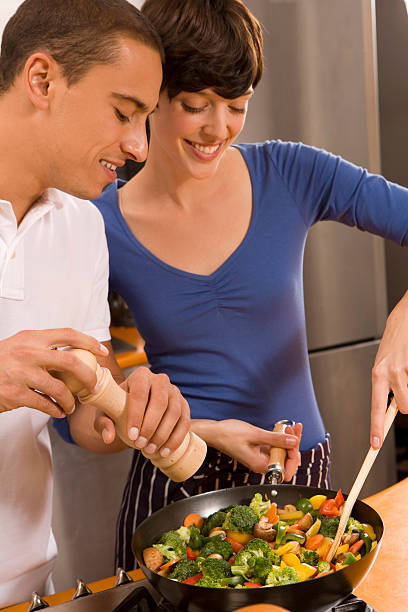 istock young couple cooking together 146964323