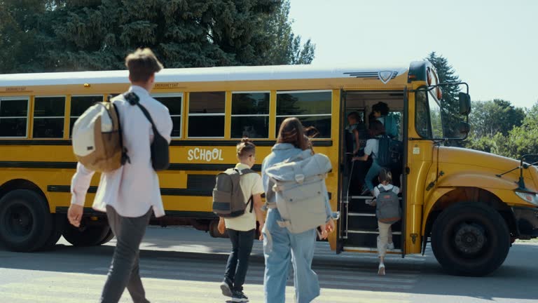 Group students running boarding schoolbus. Pupils rushing to public shuttle.