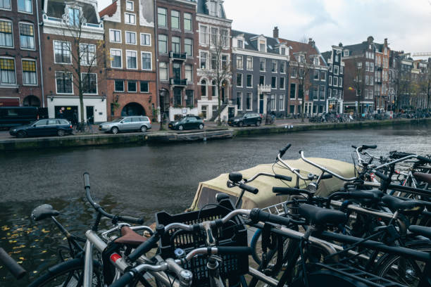 istock Riding bikes along canal in Amsterdam 1469652758