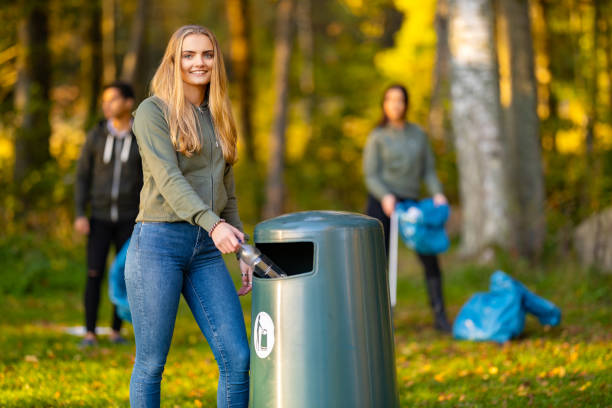 istock Smiling young woman putting bottle in garbage bin 1469652841