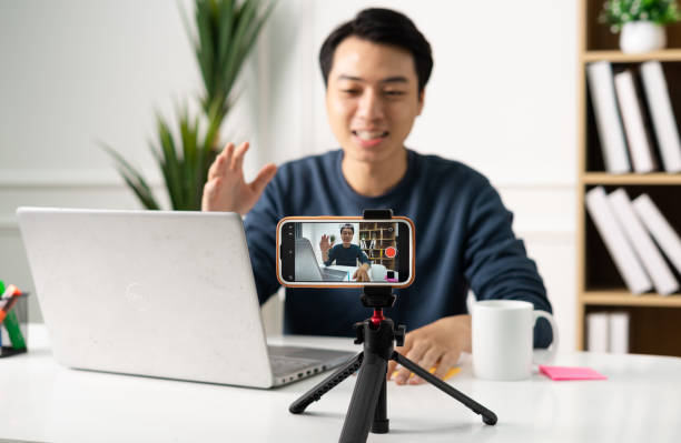 istock image of Asian man sitting at home working 1469656043