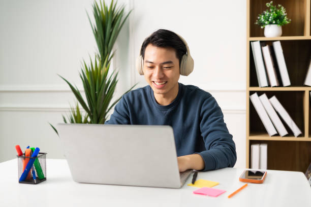 istock image of Asian man sitting at home working 1469656068