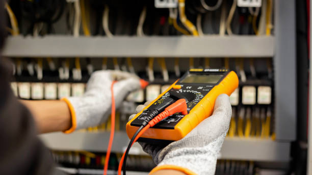 istock Electrician engineer uses a multimeter to test the electrical installation and power line current in an electrical system control cabinet. 1469656811