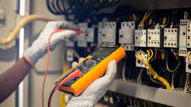 istock Electrician engineer uses a multimeter to test the electrical installation and power line current in an electrical system control cabinet. 1469656815