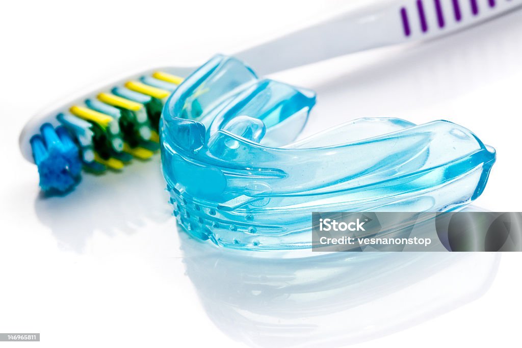 Dental bracket and a toothbrush Silicone Dental bracket and a toothbrush  closeup Mouthguard Stock Photo