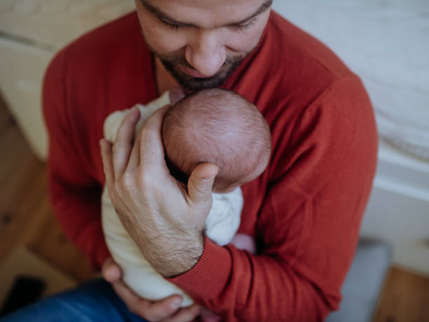 Close-up of father holding his little son. Close-up of father holding his little new born baby. father and baby stock pictures, royalty-free photos & images