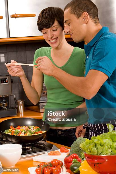 A Young Couple Cooking Up Some Vegetables In A Pan Stock Photo - Download Image Now - Adult, Adults Only, Bonding