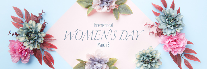 Happy Women's Day Pastel Blue and Pink Colored Banner. Flat lay floral greeting card with beautiful silk flowers.