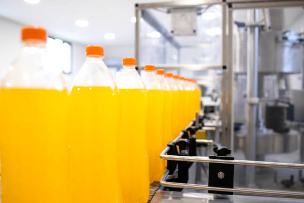 istock Bottled orange juice being produced on conveyor belt machine. 1469661837